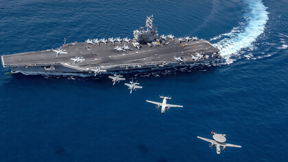 South China Sea  (Oct. 9, 2019), Aircraft from Carrier Air Wing (CVW) 5 fly in formation over the forward-deployed aircraft carrier USS Ronald Reagan (CVN 76), flagship of Carrier Strike Group 5