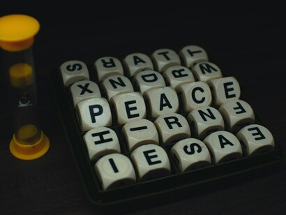 An hourglass beside the word "peace," showing how time runs out, but the need for peace does not