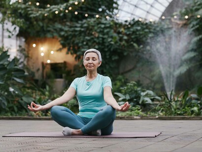 A woman placing herself in the lotus position and reminding herself to self-love