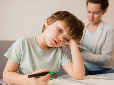 A child struggling with boredom during study time, emphasizing the link between ADHD, fetal brain development, and the influence of nutritional epigenetics on behavior