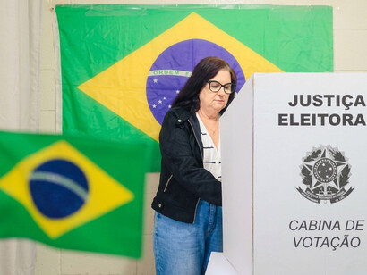 A mature Brazilian woman casts her vote at a polling station during the presidential election