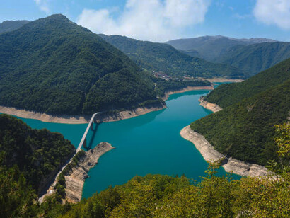 The renowned Piva Canyon, featuring a stunning bridge spanning the lake, serves as a breathtaking nature travel destination in Plužine Municipality, Montenegro