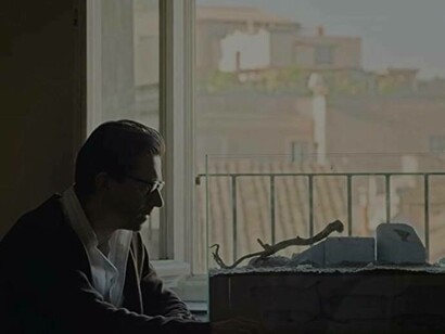 Luigi Lo Cascio reflecting in a scene from Lord of the Ants (2022) 