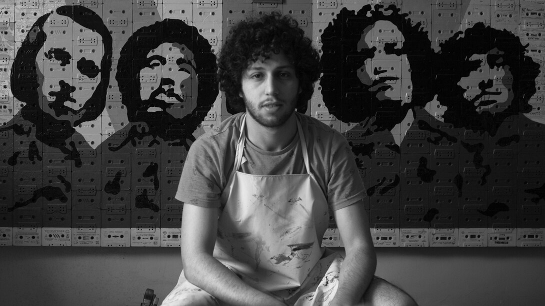 Youness Miloudi sitting in front of one his artistic pieces photo by Abdelhak Sabri