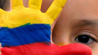 A young Venezuelan with her hand-painted in the colors of the flag