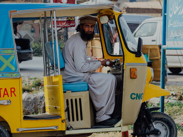 People riding a rickshaw in Chakwal, Pakistan, on the way to Lahore