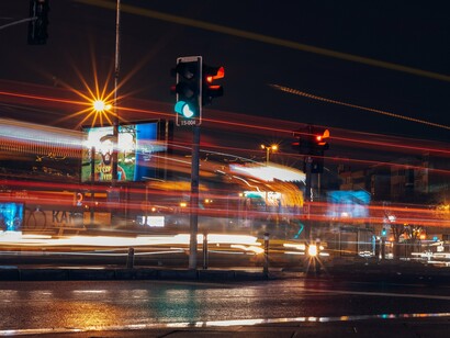 Long-exposure city traffic going through signals, representing the rapidly growing pace of technological competition