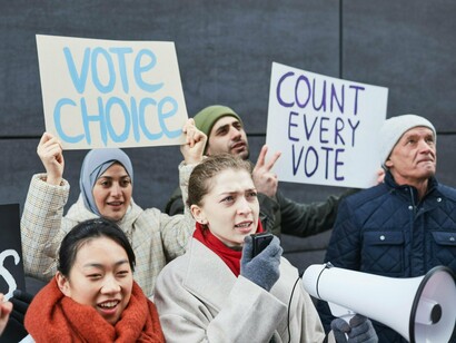 Citizens rallying for electoral justice with handwritten placards, symbolising the fight against political exclusion and voter neglect