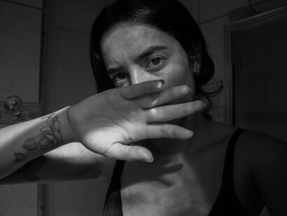 Woman covering her face with hand