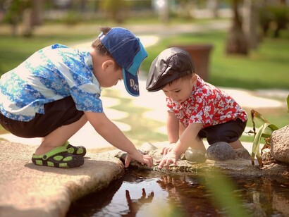 Due bambini giocano in un ruscello