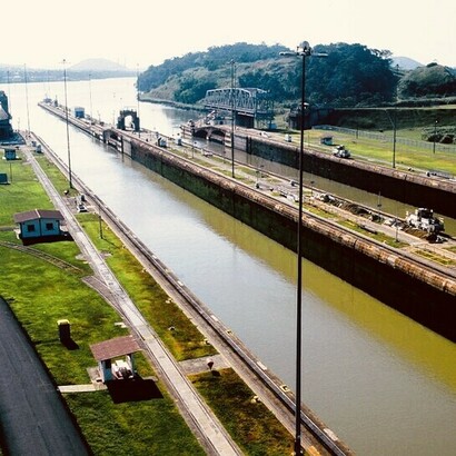 The Panama Canal is a 50-mile (80 km) long shipping canal that crosses the Isthmus of Panama in Central America, connecting the Pacific and Atlantic Oceans