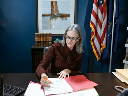 A composed woman in a political office environment, reflecting the shift toward equal representation in leadership