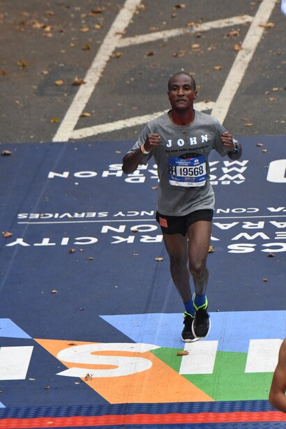 John Metui crossing the finish line at the 2017 TCS New York City Marathon