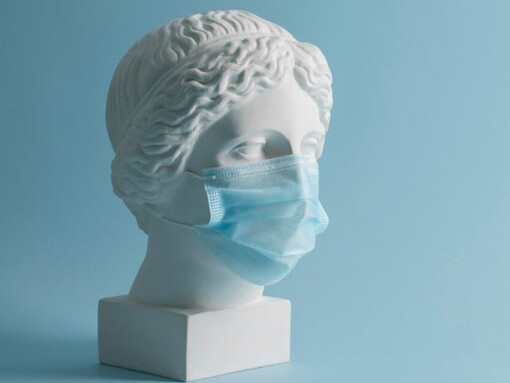 A marble sculpture of a historical figure wearing a medical mask, blending classical art with medical surrealism