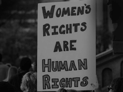 A banner reading 'Women's rights are human rights' evokes the sentiment of freedom of choice and liberty to exist