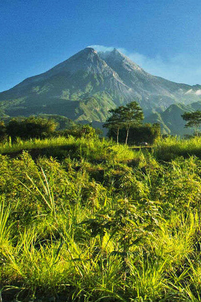 The natural beauty of Mount Merapi in Indonesia, with its rolling hills and verdant greenery, invites travelers to reflect on both the resilience of the local community and the wonders of Indonesia’s volcanic landscape