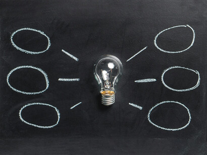 An ''idea lightbulb'' spreading into multiple scenarios and possibilities