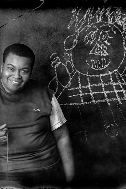 Jeannie O'Connor, Creative growth artist Jo with chalkboard drawing, 2016. Courtesy of Transmission Gallery