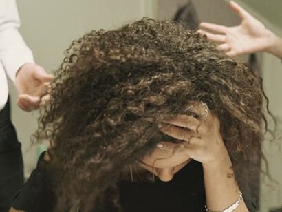 Surrounded by shouting superiors, the distress on her face captures the toxic environment created by ineffective leadership, where fear trumps motivation