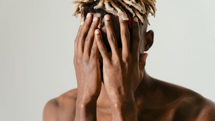 Homem encobre o rosto com vergonha