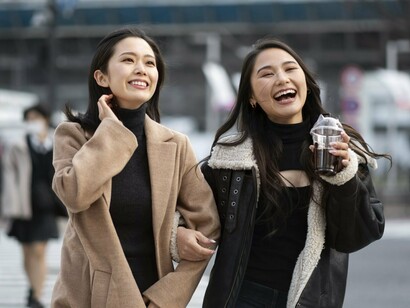 Simply dressed Japanese women walking together, representing the societal inclination toward uniformity