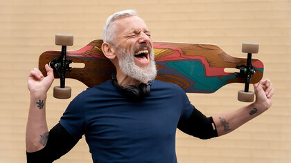 A content mature man, happily riding a skateboard, embodies the joy of taking-risk, adventures