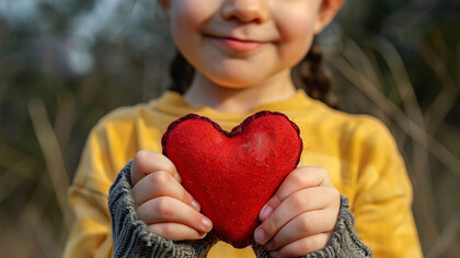 Hands forming a heart, symbolizing peace, love, and the universal bond of humanity