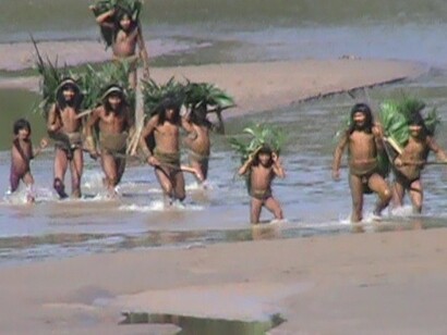 The Mashco-Piro tribe crossing a river, ©Survival International/ FENAMAD