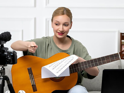 Discover the allure of e-learning with an enchanting image of a young, cute, and beautiful girl teaching guitar remotely from her home, highlighting the accessibility and charm of virtual education