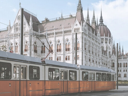 Beautiful old school yellow tram on Budapest Streets near Hungarian Parliament, Hungary