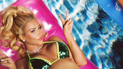 Kim Kardashian transformed into a barbie bimbo floating in a swimming pool