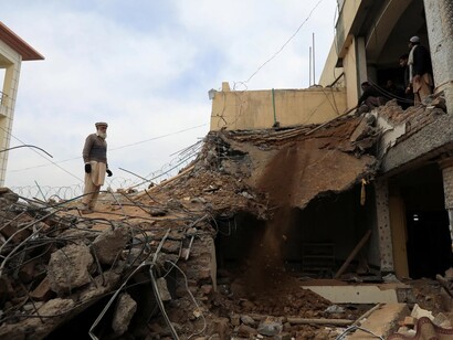Pakistani man in the ruins of his own home after the flooding, now homeless