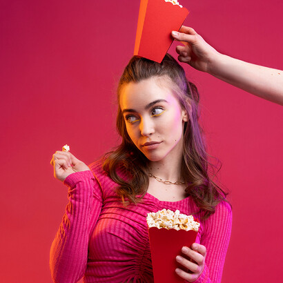 Menina com pipoca. Tem como a base e plano de fundo o filme de 2004