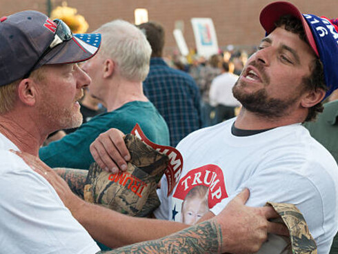 Tensions rise as a Trump supporter argues with police at a protest scene