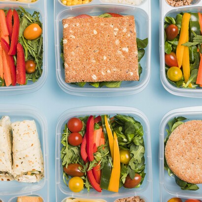 Colorful containers of fresh vegetables and whole grains reflect the modern Olympic commitment to tailored athlete nutrition