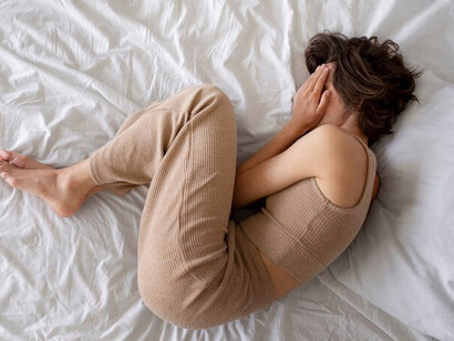 Flat lay of a woman struggling with anxiety, symbolizing OCD and emotional distress