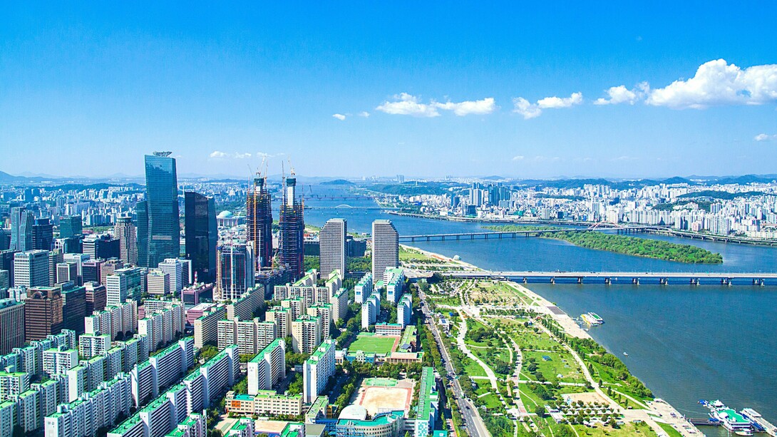 Seoul's expansive skyline stretching beyond the Han River, reflecting a nation that invested in capability before prosperity
