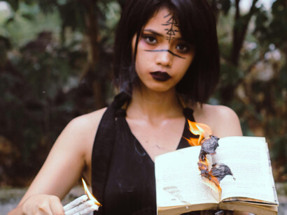 Fire erupts from the pages, as the incantation begins