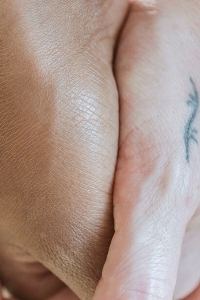 Two people holding hands to shown human connection