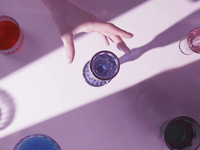 Each cup reflects its surroundings, echoing the idea that identity can be multifaceted and shaped by perception