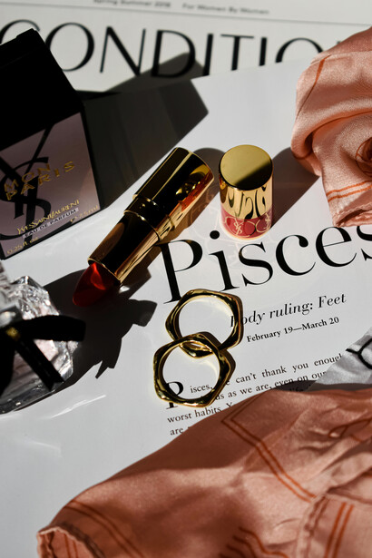 Lipstick and rings featured on a magazine page