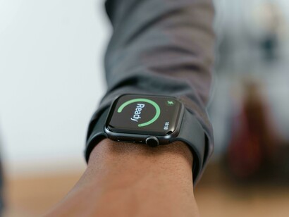Close-up shot capturing a person’s hand operating a smartwatch display