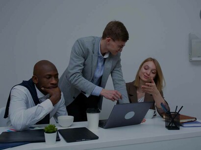 A trio of business students discussing the proposal they wish to submit and pitch to investors