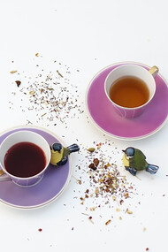 Two cups of drinks stand on a white background
