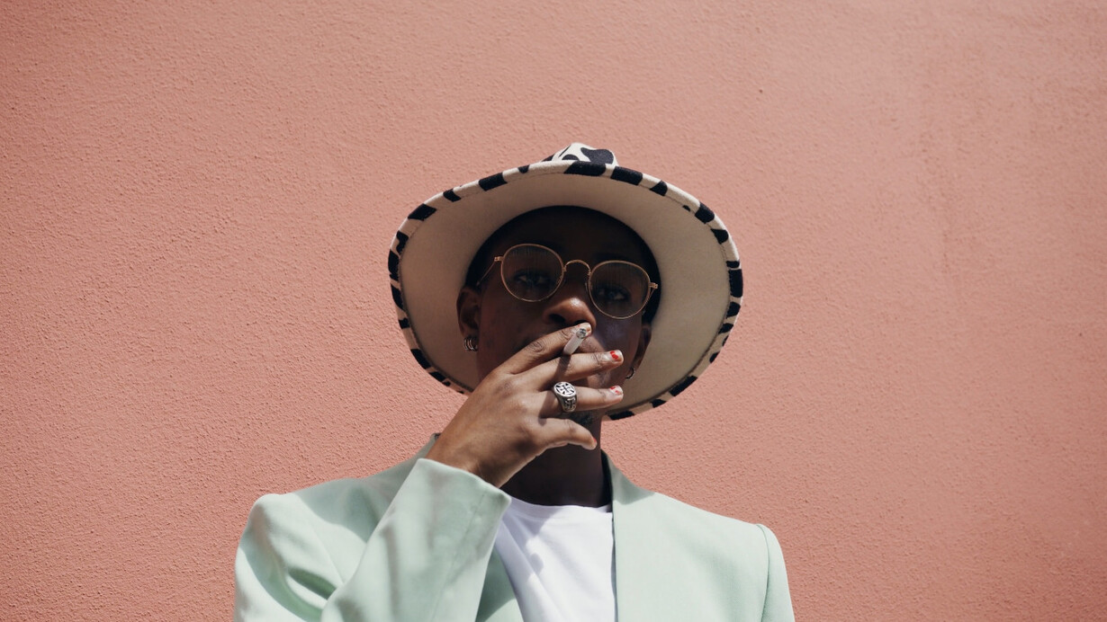 Basking in the sun, he reflects the allure of a lifestyle that increasingly intertwines with nicotine culture in urban Kenya