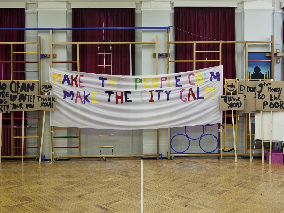 Peter Liversidge, Notes on Protesting, school rehearsal, April 2014. Cotton, iron on, cardboard & wood © Peter Liversidge