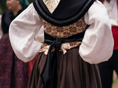 A woman dressed in traditional folklore attire showcases the importance of cultural heritage preservation, highlighting cultural identity, diversity, and the richness of traditional festivals