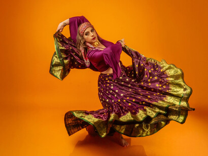 A woman dancing in a traditional dress