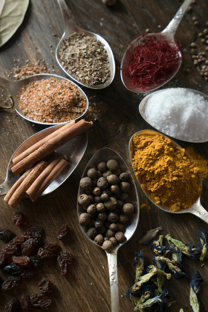 An assortment of spices and herbs arranged on spoons, symbolizing the Caucasus tradition of herbal remedies and natural medicine