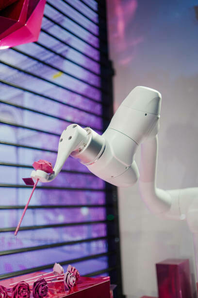 The installation features a robot arm handing over a plastic rose, highlighting a robotic flower installation that combines AI and floral design through precise robotic rose picking, with industrial robots delicately picking flowers